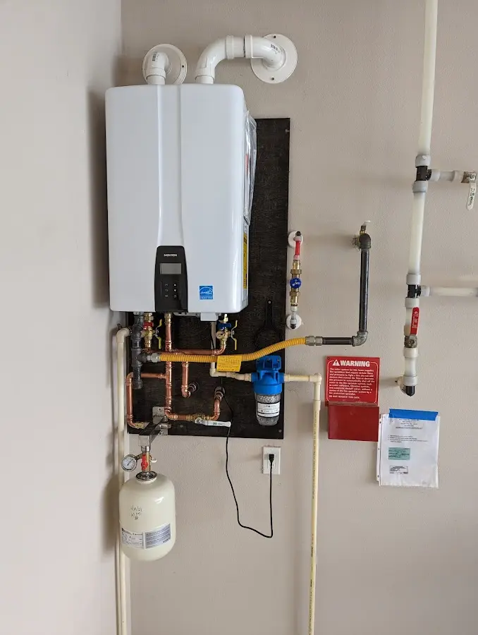 Professional plumber installing copper piping in a Brenham home